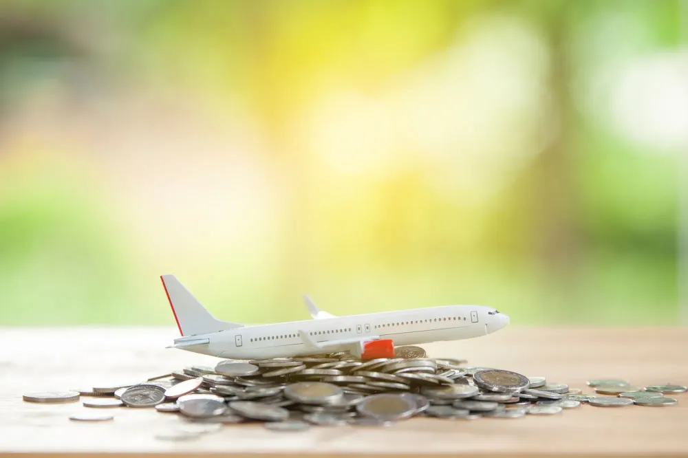 Model plane on pile of coins